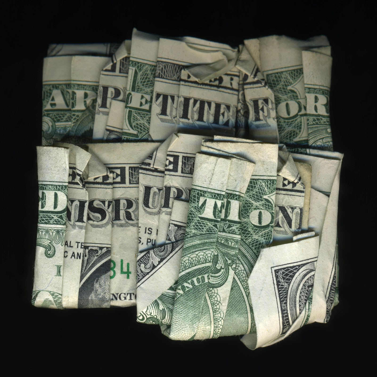 Œuvre de Dan Tague : billets d’un dollar pliés formant les mots Appetite for Disruption